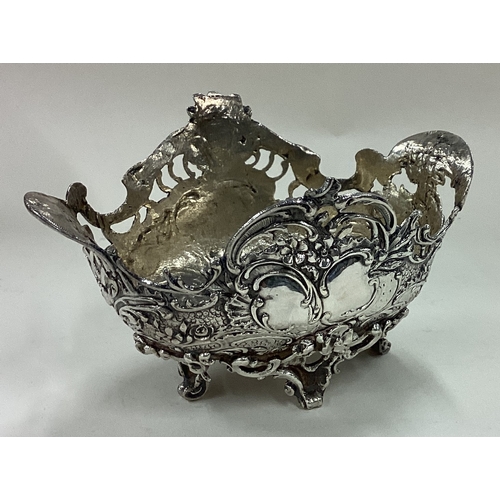 9 - A chased silver basket with pierced decoration. Approx. 143 grams. Est. £120 - £150.