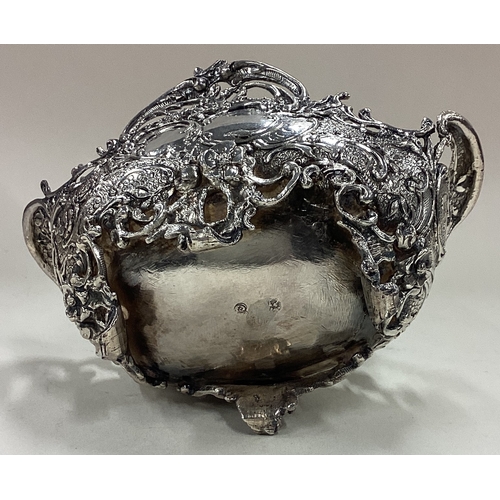 9 - A chased silver basket with pierced decoration. Approx. 143 grams. Est. £120 - £150.