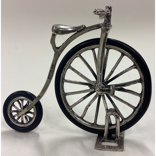 91 - A Sterling silver table toy model of a penny-farthing. Approx. 15 grams. Est. £30 - £40.