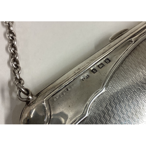 95 - A good quality engine turned silver purse on suspension chain. Approx. 83 grams. Est. £40 - £60.