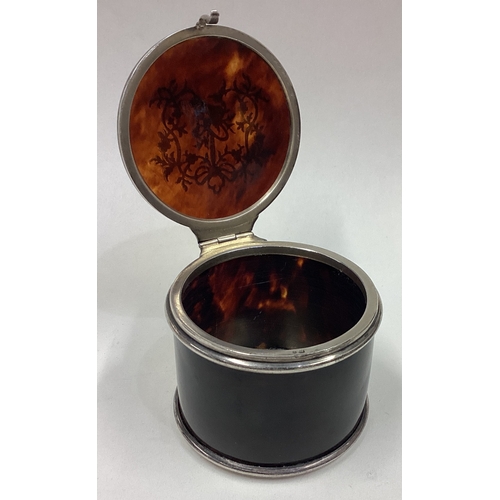 99 - A circular silver and tortoiseshell jewellery box with floral decoration. Approx. 69 grams of gross ... 