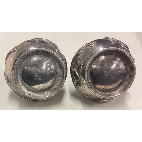 251 - A pair of 19th Century Chinese export silver peppers embossed with dragons. Marked to base. Circa 19... 