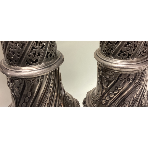 350 - A large pair of Victorian silver sugar casters. London 1888. By Thomas Bradbury & Sons. Approx. 569 ... 