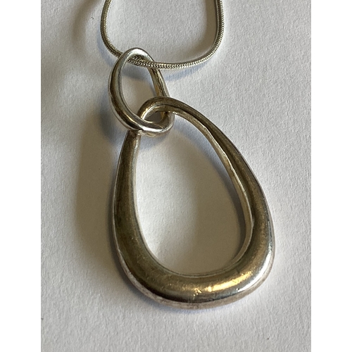 694 - A heavy silver pendant on chain together with a silver bracelet. Approx. 27 grams. Est. £20 - £30.