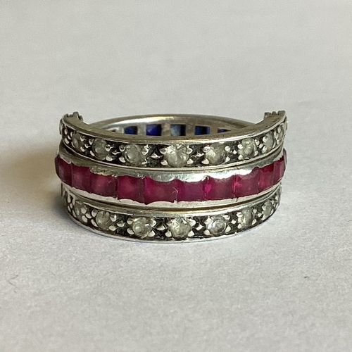 704 - A sapphire, ruby and diamond hinged 'night and day' ring set in platinum. Approx. 4 grams. Est. £250... 