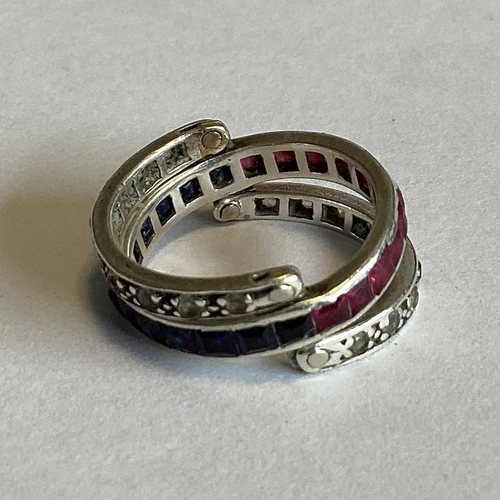 704 - A sapphire, ruby and diamond hinged 'night and day' ring set in platinum. Approx. 4 grams. Est. £250... 