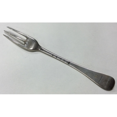 115 - An 18th Century silver three prong fork. Marked to base. Approx. 28 grams. Est. £80 - £120.