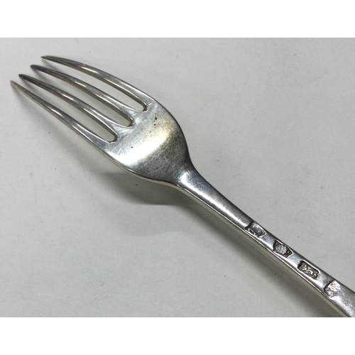 118 - An 18th Century silver four prong fork. Marked to base. Approx. 64 grams. Est. £80 - £120.