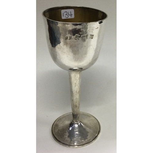 134 - A Modernistic hammered silver goblet. Birmingham 1972. By WC. Approx. 104 grams. Est. £100 - £150.