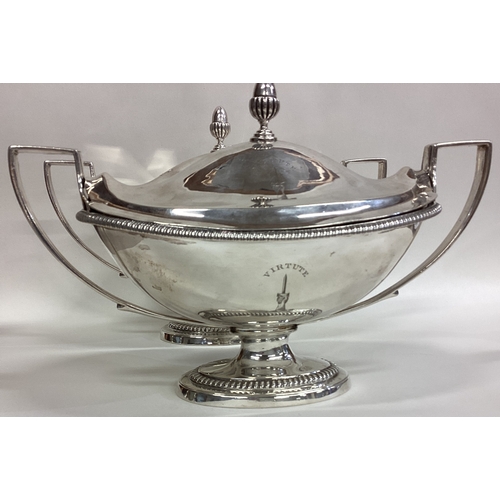 144 - A fine pair of Georgian silver tureens and covers with gadroon rims to reeded handles and crested ar... 