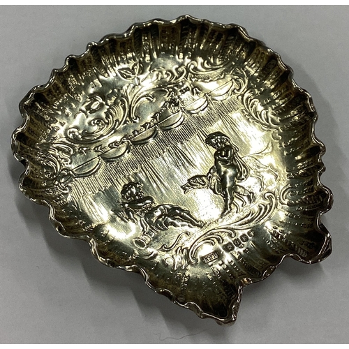 15 - A Victorian silver chased dish embossed with cherubs and dogs bearing import marks. London 1891. App... 