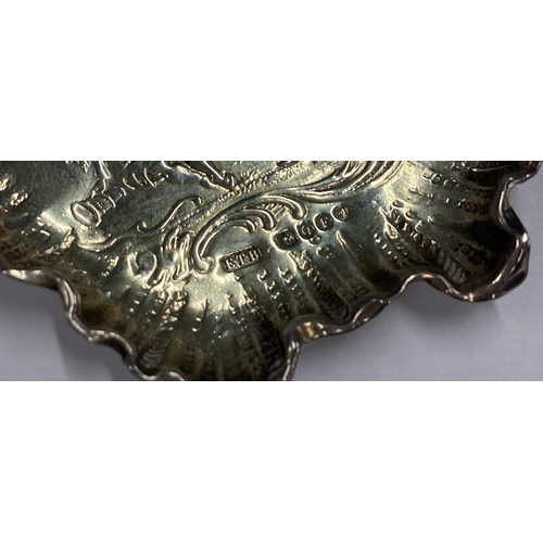 15 - A Victorian silver chased dish embossed with cherubs and dogs bearing import marks. London 1891. App... 