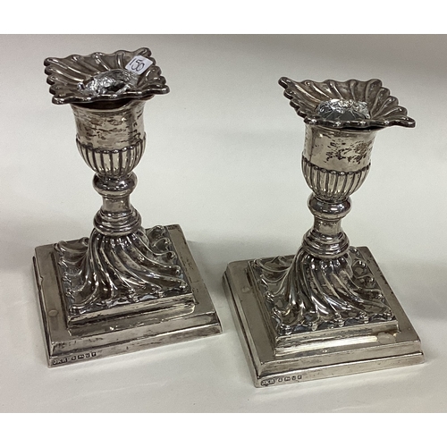 150 - A pair of Victorian silver candlesticks on square bases. Sheffield 1888. By JKR. Approx. 846 grams o... 