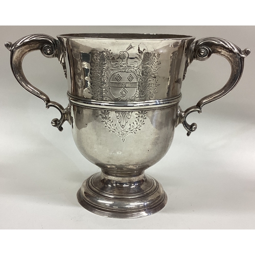 157 - A large 18th Century Provincial silver two-handled cup with central armorial. Maker's mark only. App... 