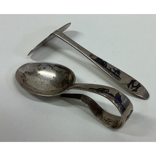 164 - A Persian silver and Niello spoon and pusher. Approx. 46 grams. Est. £50 - £80.