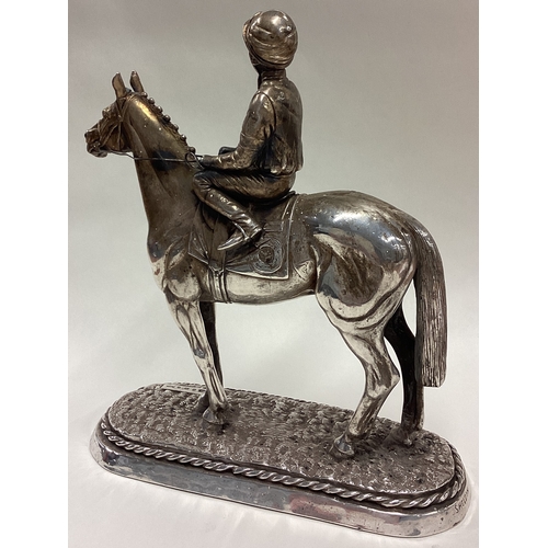 194 - A large silver figure of a jockey on horse, inscribed 'Sheldon'. 1987. Approx. 1133 grams of gross w... 