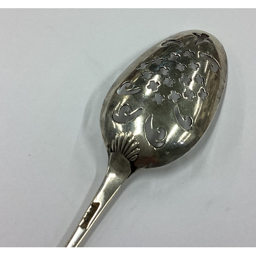 198 - An 18th Century silver shell back mote spoon. Marked to back. Approx. 8 grams. Est. £100 - £150.