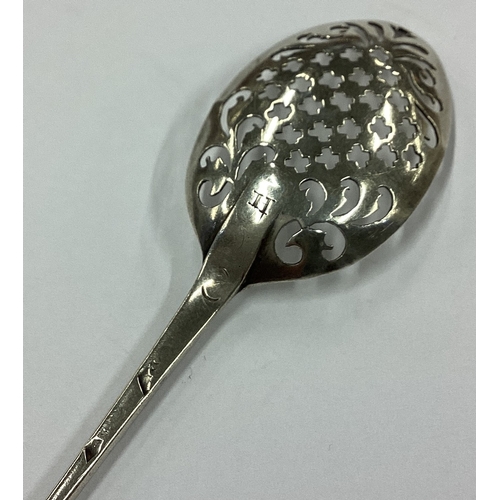 203 - An 18th Century Provincial silver cross pattern mote spoon. Maker's mark struck twice 'TW'. Approx. ... 