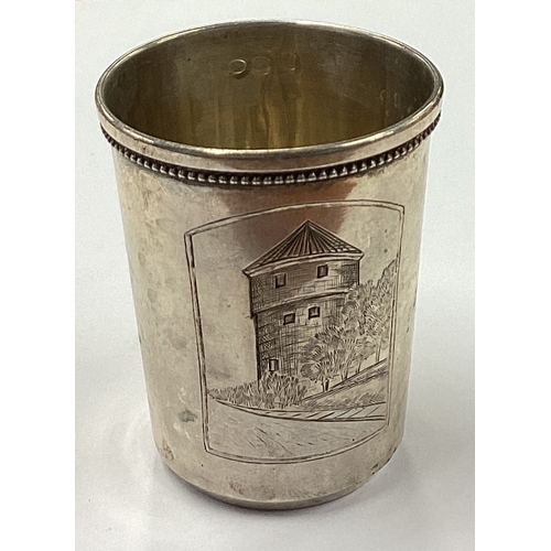 238 - A Russian silver vodka tot engraved with castle scene. Marked 875. Approx. 19 grams. Est. £30 - £50.