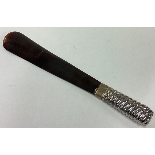 241 - A tortoiseshell shoe horn. Est. £10 - £20.