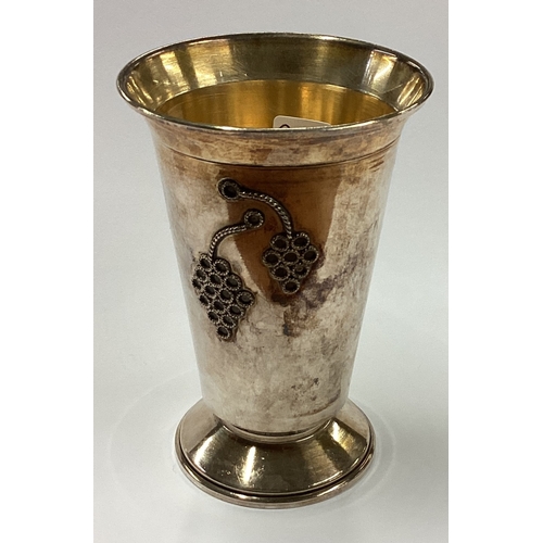 242 - A Judaica silver kiddush cup embossed with vines and Hebrew inscription. Marked Sterling to base. Ap... 