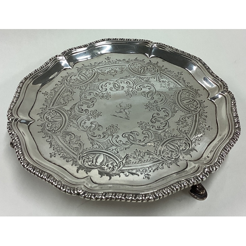 243 - A good 18th Century silver salver with engraved decoration and central armorial. London 1763. By Tho... 