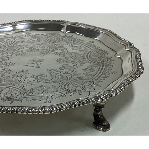 243 - A good 18th Century silver salver with engraved decoration and central armorial. London 1763. By Tho... 