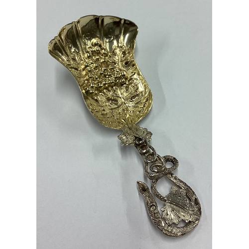 249 - A fine quality Victorian silver caddy spoon of naturalistic form decorated with grapes and vines. Bi... 