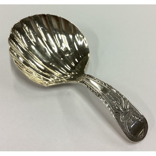 255 - A large George III silver shell back caddy spoon. London 1832. Approx. 6 grams. Est. £50 - £80.