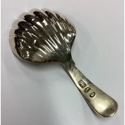 255 - A large George III silver shell back caddy spoon. London 1832. Approx. 6 grams. Est. £50 - £80.