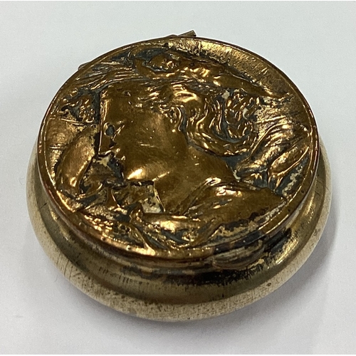 276 - A metal pill box with hinged cover embossed with scene of a man. Est. £20 - £30.