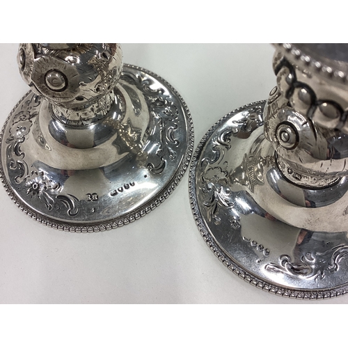 278 - A novelty pair of Victorian silver chambersticks embossed with owls. London 1863. By Robert Hennell.... 