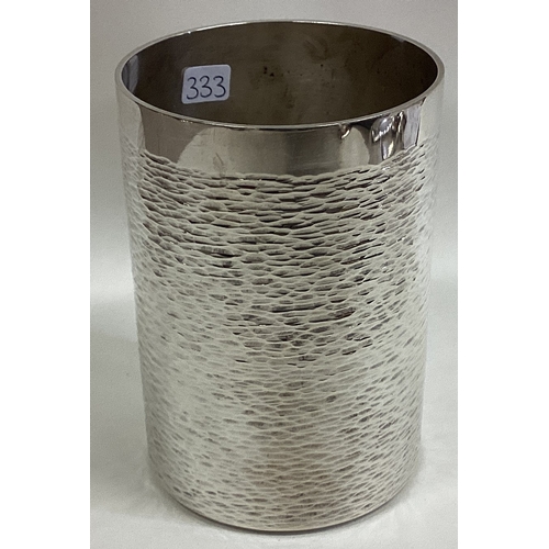 333 - STUART DEVLIN: A large contemporary silver beaker of hammered design. London 1977. Approx. 232 grams... 