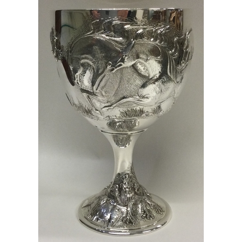 337 - A rare and unusual chased silver goblet embossed with horses and stags to body, and embossed crowned... 