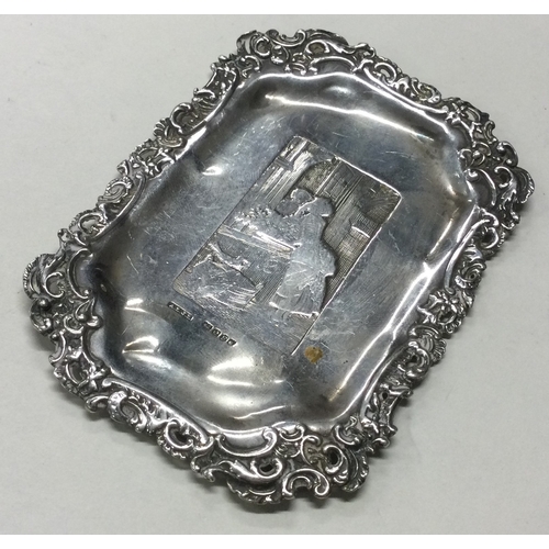 380 - A chased silver dish with scene to centre bearing import marks. Approx. 28 grams. Est. £30 - £50.