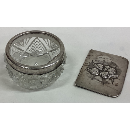 383 - A silver and glass salt together with a book cover embossed with cherubs. Birmingham. Est. £10 - £20... 