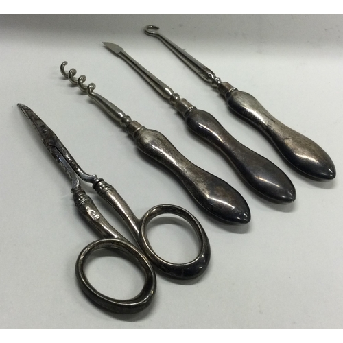 387 - A silver handled manicure set. Birmingham 1905. Approx. 67 grams. Est. £20 - £30.