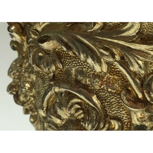 388 - A rare Edwardian silver gilt cup and cover heavily embossed with flowers to cherub finial. London 19... 