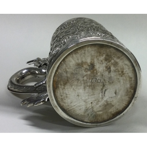 405 - A rare Chinese export silver mug embossed with grapes, vines and dragon handle. Character marks to b... 