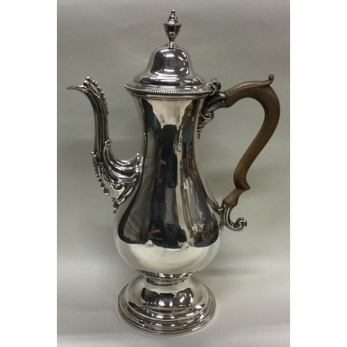 413 - A large oversized 18th Century George III silver coffee pot. London 1783. By Benjamin Montague. Appr... 