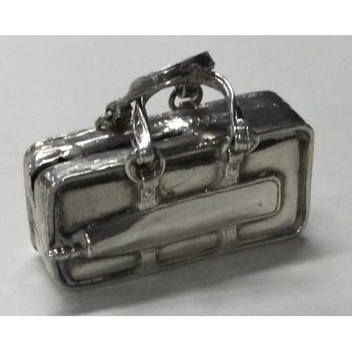 426 - A Sterling silver toy model of a suitcase. Approx. 38 grams. Est. £40 - £60.