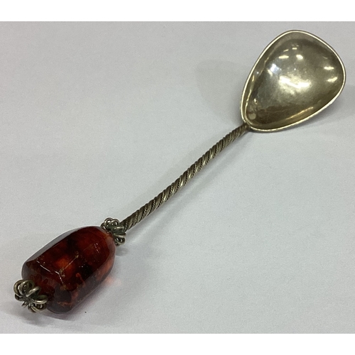 447 - An Arts and Crafts silver spoon with stone top. Approx. 15 grams. Est. £20 - £30.