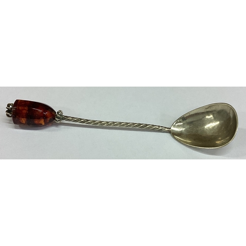 447 - An Arts and Crafts silver spoon with stone top. Approx. 15 grams. Est. £20 - £30.