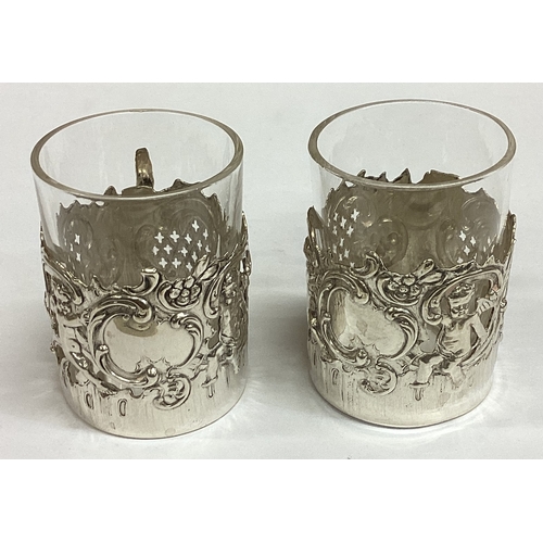 463 - A pair of pierced Victorian silver vodka tots chased with cherubs bearing import marks. Approx. 43 g... 