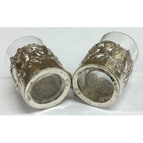 463 - A pair of pierced Victorian silver vodka tots chased with cherubs bearing import marks. Approx. 43 g... 