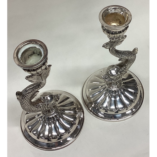 464 - A pair of Sterling silver candlesticks in the form of dolphins. Approx. 520 grams of gross weight. E... 