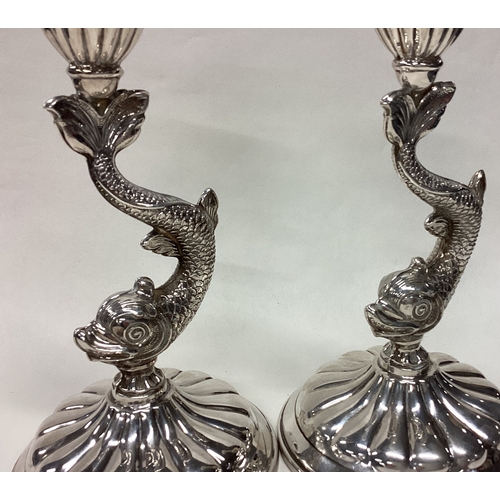 464 - A pair of Sterling silver candlesticks in the form of dolphins. Approx. 520 grams of gross weight. E... 