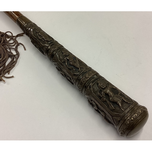 474 - An Eastern silver mounted umbrella decorated with figures. Est. £30 - £50.