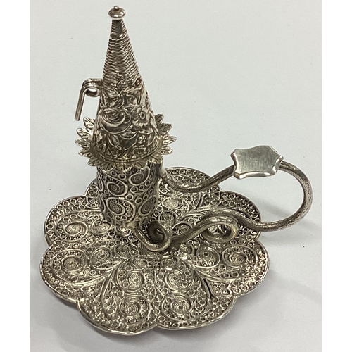 5 - A fine quality miniature silver chamberstick with filigree decoration and matching extinguisher. Bir... 