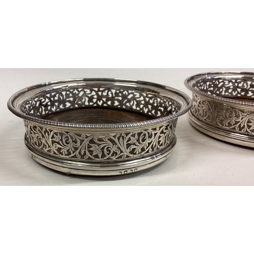 551 - A pair of George III pierced silver wine coasters. London 1803. Approx. 470 grams. Est. £600 - £800.